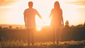 A picture depicting a couple holding hands