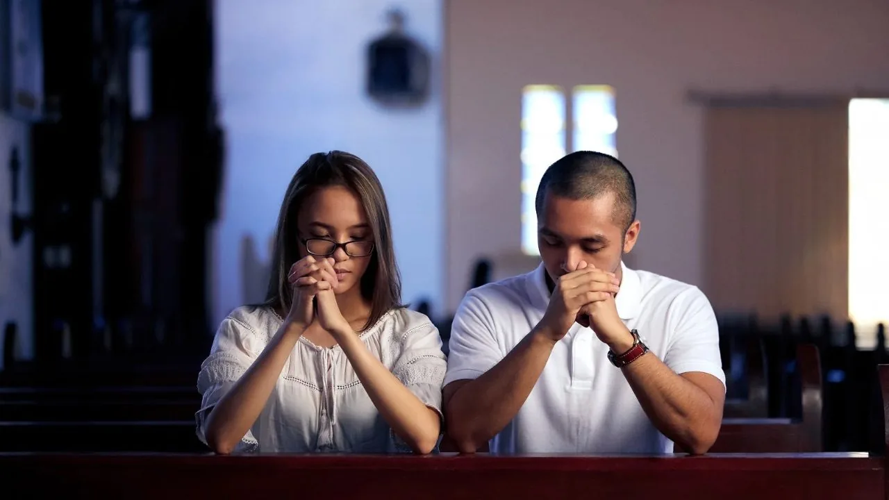 Man and woman on their knees praying