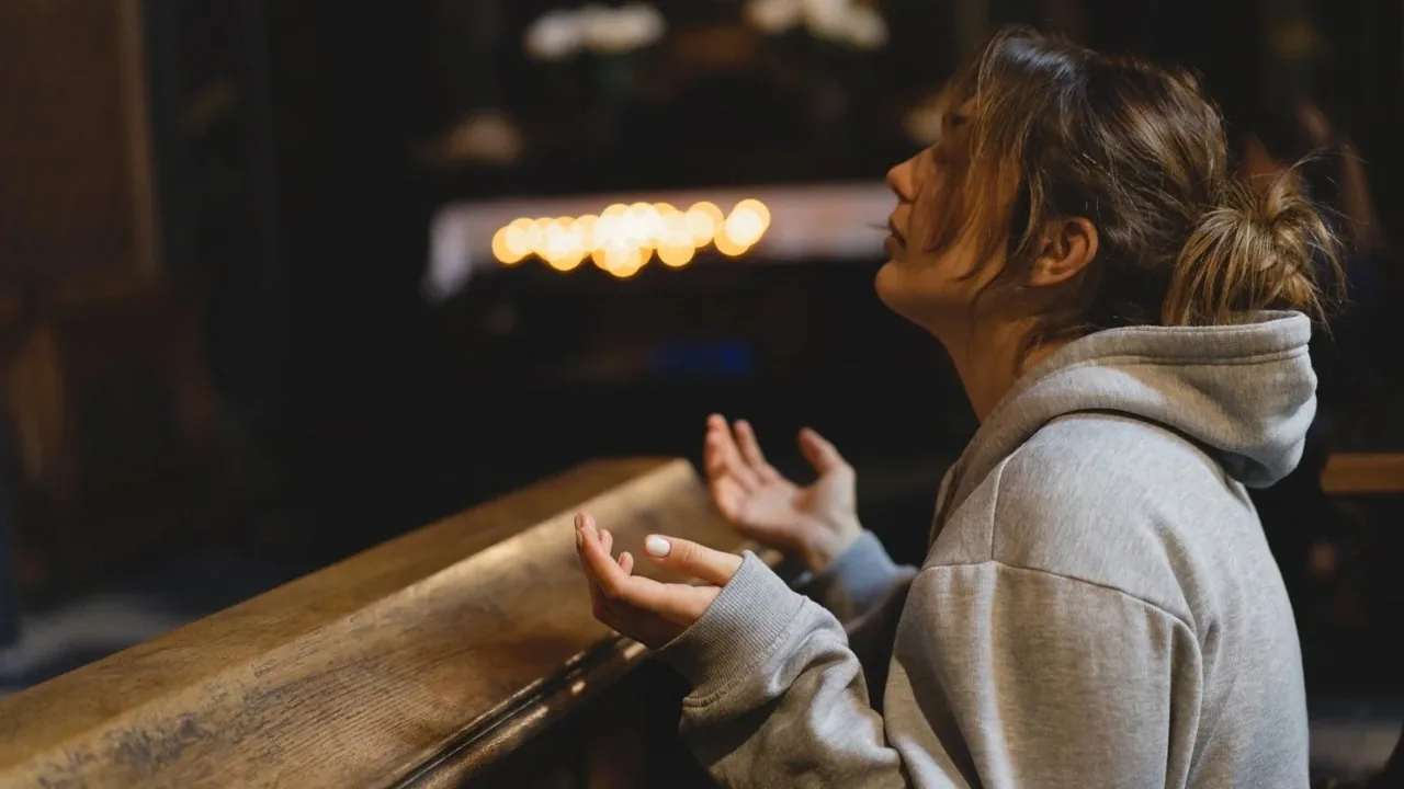 Woman praying in a church